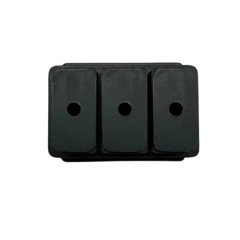 Black rubber block with three holes.